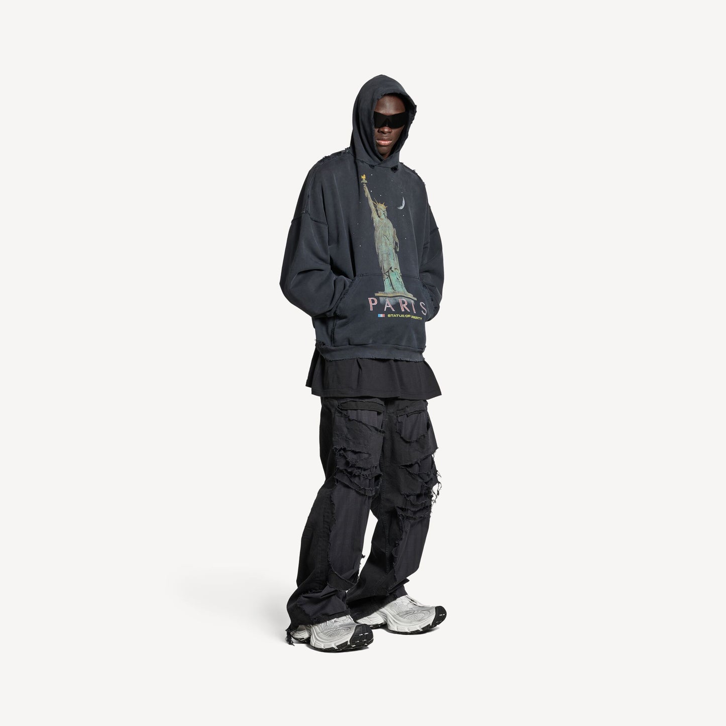 a dark hoodie and cargo pants