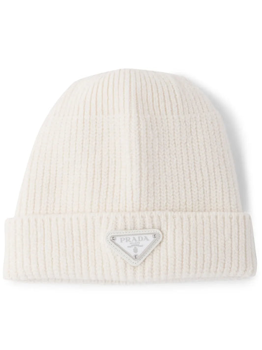 White ribbed knit beanie with Prada logo on a white background